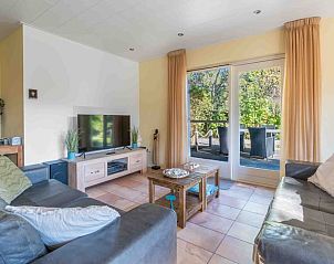 Cozy living room of Landhuis Tempelierweg 22 in Texel with comfortable seating area.