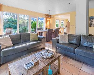 Spacious living room of Landhuis Tempelierweg 22 in Texel overlooking the garden.