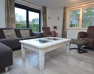 Vacation home de Parel 214, De Dennen, Texel, with comfortable seating area and large windows for a beautiful view.