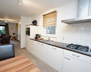 Light and functional kitchen in Holiday home de Parel 214, De Dennen, Texel, ideal for culinary adventures.