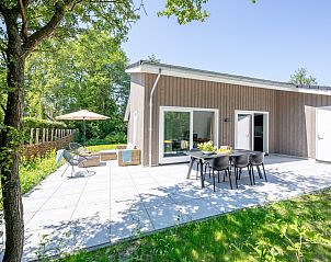 Spacious terrace at vacation home Tormentil in De Dennen, Texel, perfect for outdoor dining and relaxing.