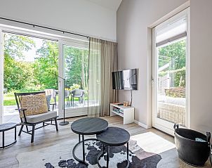 Bright living room overlooking the garden in vacation home Tormentil, De Dennen, Texel.