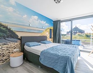 Bedroom of Strandvilla Hygge, De Dennen, Texel, with beach theme and access to terrace.