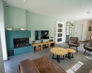 Modern living room in Holiday home de Parel 174, De Dennen, Texel with comfortable seating area.