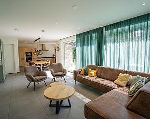 Cozy indoor area of Holiday Home de Parel 174, Texel overlooking the garden.