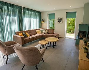 Bright living room in Holiday home de Parel 174, De Dennen, Texel with large windows.