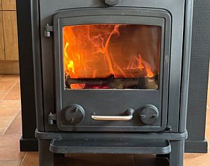Cozy wood stove in the living room of Hesselte vacation home, De Dennen, Texel.