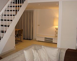 Gerumiges Wohnzimmer mit Essecke und Treppe im Ferienhaus Gortersmient 354 in De Dennen Texel.