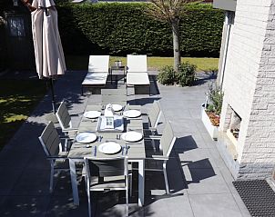 Auenbereich des Ferienhauses Gortersmient 358 in De Dennen, Texel mit Esstisch und Liegesthlen.