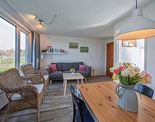 Dining area with flowers in Langsteert vacation home, De Dennen, Texel, Wadden Islands.