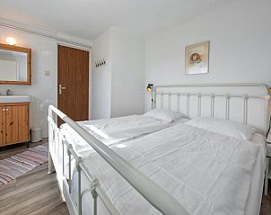 Bright bedroom with double bed in Langsteert vacation home, De Dennen, Texel, Wadden Islands.