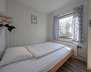 Small bedroom with window in Langsteert vacation home, De Dennen, Texel, Wadden Islands.