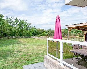 Ruim grasveld bij Wulpenweid 12 de Meeuw in De Dennen Texel, omringd door natuur.