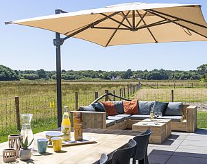 Enjoy the terrace at Holiday home 1 in De Dennen Texel, overlooking the nature of the Wadden Islands.
