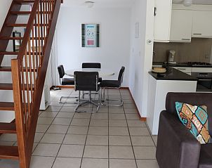 Cozy sitting area in Holiday Home Gortersmient 260, De Dennen, Texel with comfortable sofa and colorful pillows.