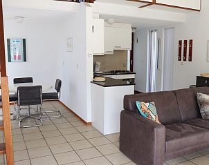 Modern kitchen in Holiday Home Gortersmient 260, De Dennen, Texel with dining area and stairs to upper floor.