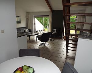 Dining area overlooking garden in Holiday home Gortersmient 260, De Dennen, Texel.