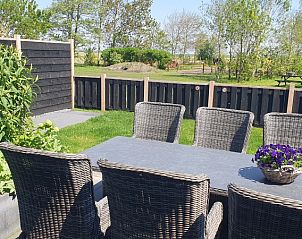 Sunny terrace at Helianthus vacation home in De Dennen, Texel overlooking nature.