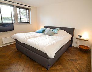 Comfortable bedroom in Bungalowpark Oud Vredelust - Zeeskuum, Texel with large bed