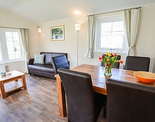 Cozy living room in Holiday Park De Koorn-aar Type F, Texel, with comfortable sitting area and dining area.