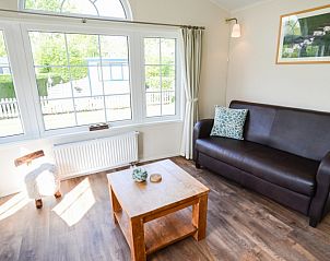 Modern living room overlooking the garden in Holiday Park De Koorn-aar Type F, Texel.