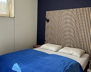 Gezellige slaapkamer met blauw dekbed in De Hoek vakantiehuis, Hoorn, Terschelling.