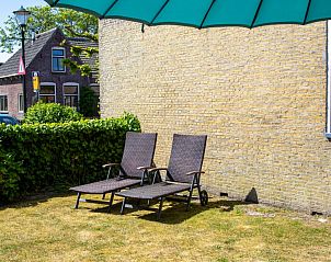 Rustige tuin van Casa Juan Carlos vakantiehuis in Hoorn, Terschelling met ligstoelen.