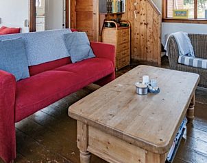 Ruime zithoek in BosenDuin vakantiehuis, West aan Zee, Terschelling met houten tafel.