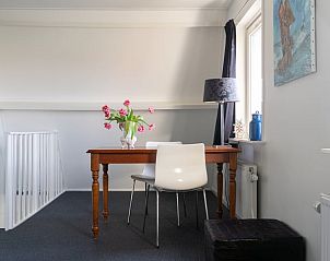 Bright dining area in Holiday home in Ballum, Ameland, overlooking the garden.