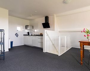 Modern kitchen in Holiday home in Ballum, Ameland, with dining area and appliances.