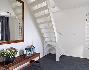 Entrance with stairs in Holiday home in Ballum, Ameland, with decorative elements.