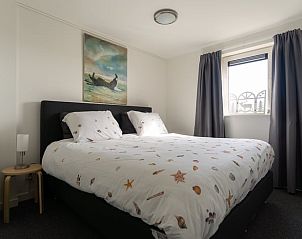 Bedroom in Holiday Home in Ballum, Ameland, with double bed and artwork.