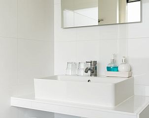 Stylish bathroom with sink in Holiday home in Ballum, Ameland.