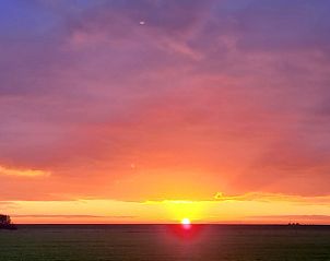 Colorful sunset over the horizon at Holiday home in Ballum, Ameland.