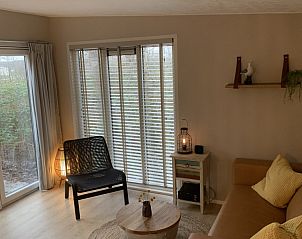 Gezellige woonkamer van Chalet2rent Ameland met uitzicht op de natuur in Ballum.