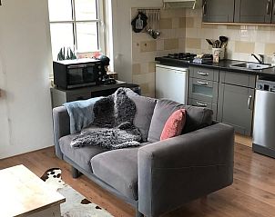 Gemtliches Wohnzimmer mit offener Kche im Ferienhaus in Buren Ameland.