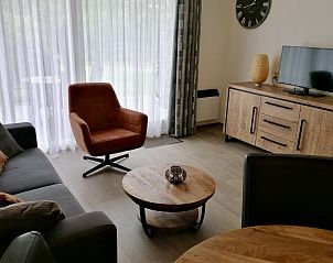 Gezellige woonkamer in Appartment Amelander Kaap, Hollum, Ameland met comfortabele zitbanken en moderne inrichting.