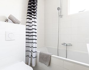 Frisse badkamer in Bornrif appartement, Hollum, Ameland met douche en bad.