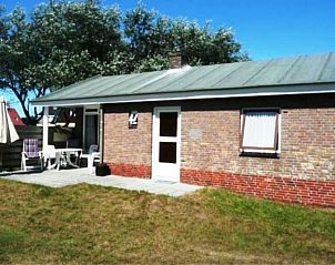 Zonnig terras van bungalow Klasina in Nes, Ameland, ideaal voor buitenontbijtjes en ontspanning op de Waddeneilanden.
