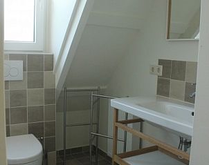 Moderne badkamer in Westhoek, Schiermonnikoog, met strakke lijnen en natuurlijk licht.