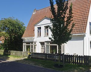Zijaanzicht van Klaver Vier vakantiehuis op Schiermonnikoog met omheining.