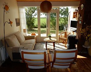 Lichte woonkamer van Buutvrij vakantiehuis op Schiermonnikoog met uitzicht op natuur.