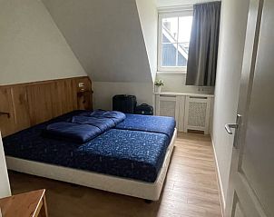 Gemtliches Schlafzimmer in Huisje in Schiermonnikoog, Ferienhaus auf Schiermonnikoog mit Holzdetails.